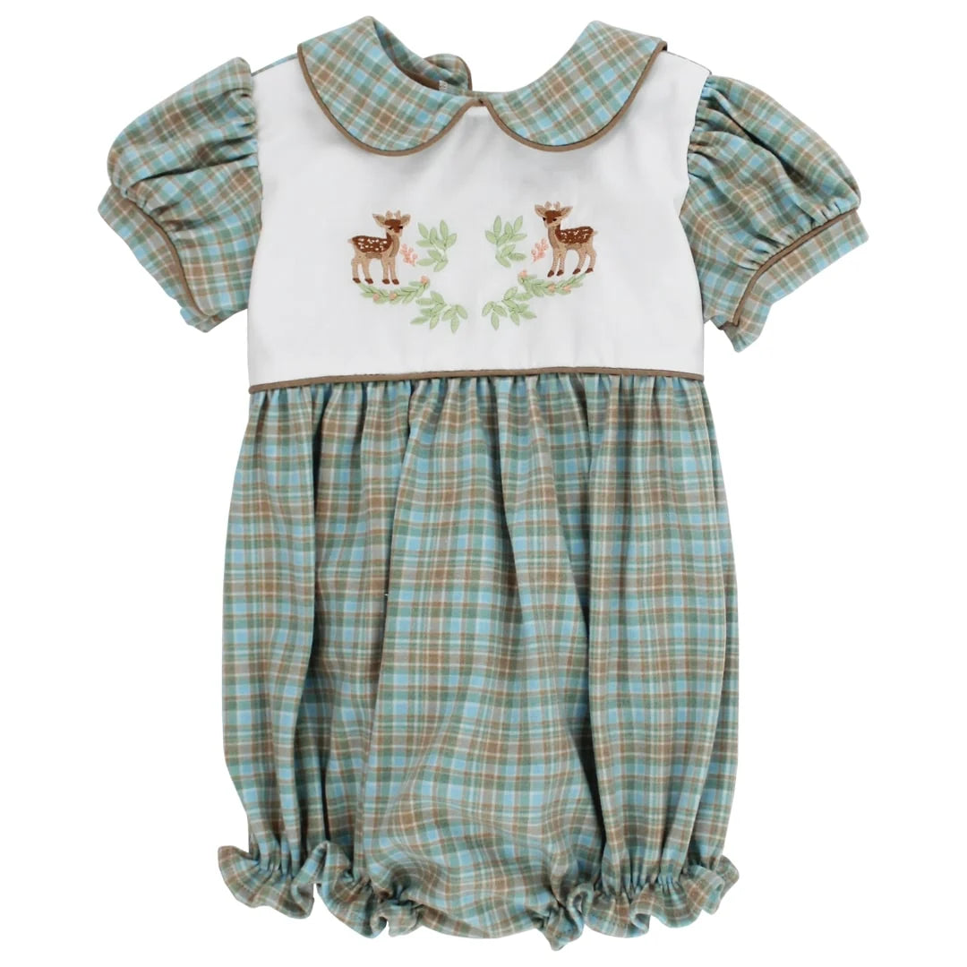 A baby romper with a white bib-style bodice featuring embroidered deer and green leaves, paired with a light blue and tan plaid skirt and matching plaid short sleeves.