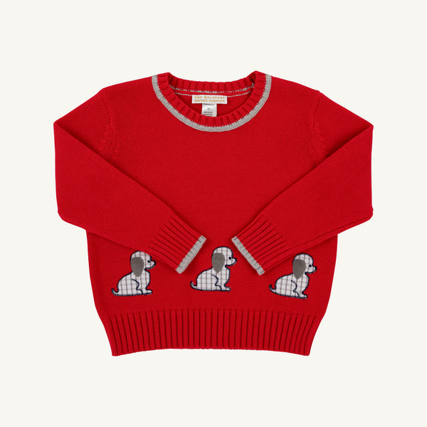 A red knit sweater with three embroidered dog motifs across the lower front, featuring gray and white plaid details on the collar, cuffs, and dog patterns, shown against a light off-white background.