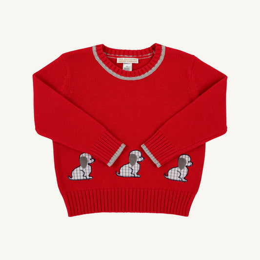 A red knit sweater with three embroidered dog motifs across the lower front, featuring gray and white plaid details on the collar, cuffs, and dog patterns, shown against a light off-white background.