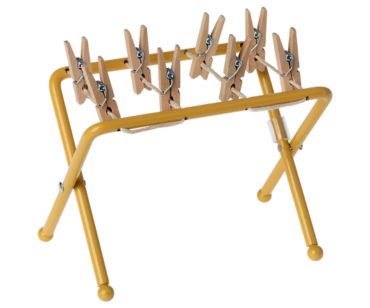 Yellow clothespin rack with wooden pegs for maileg mouse