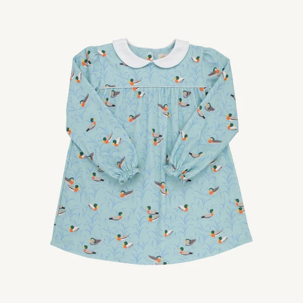 A light blue long-sleeve baby dress with an all-over duck print, featuring a white Peter Pan collar and elasticized cuffs, laid flat against a light cream background.
