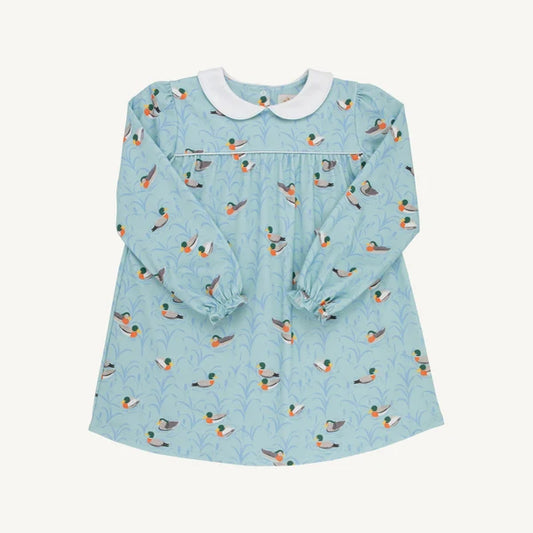 A light blue long-sleeve baby dress with an all-over duck print, featuring a white Peter Pan collar and elasticized cuffs, laid flat against a light cream background.