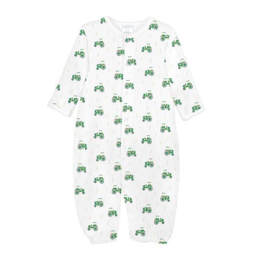 A white long-sleeve baby footless sleeper with an all-over green tractor pattern, shown flat against a white background.