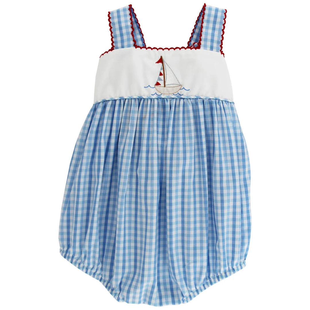 Blue checkered romper with sailboat design on a white background with bow in back 