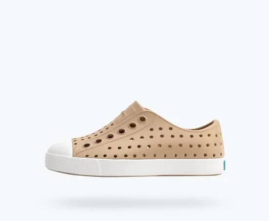 Beige/Tan sneaker with white sole on a white background