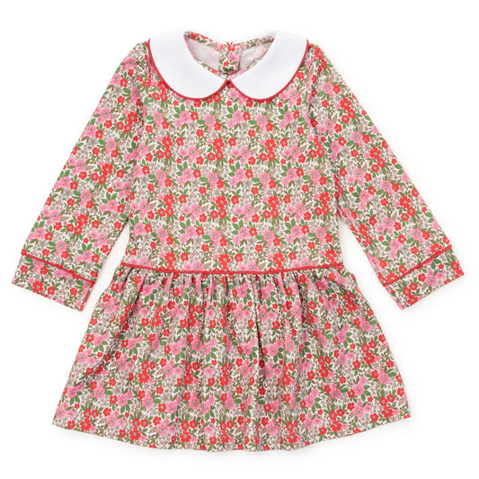 A long-sleeve children's dress with a pink and red floral print on a light background, featuring a contrasting white Peter Pan collar and red piping details.