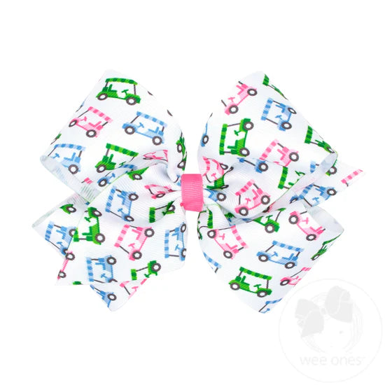 Pink, blue and green golf cart design on a white hair bow.