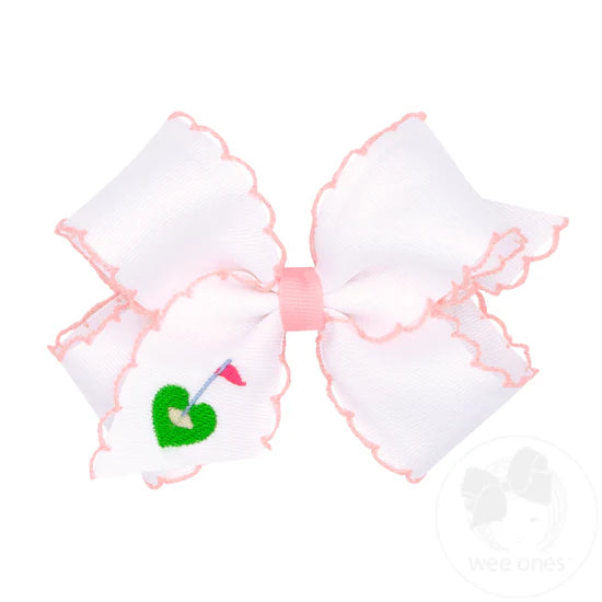 White hair bow with pink moonstitch edging and an embroidered golf tee.