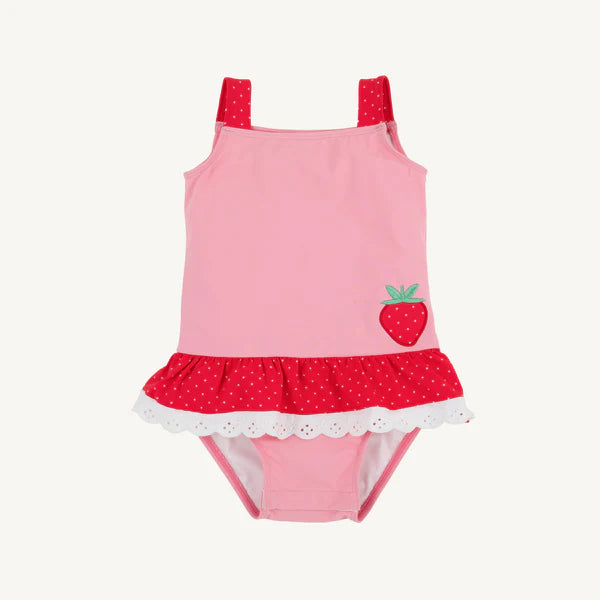 Pink and red children's swimsuit with strawberry design and eyelet trim around waist