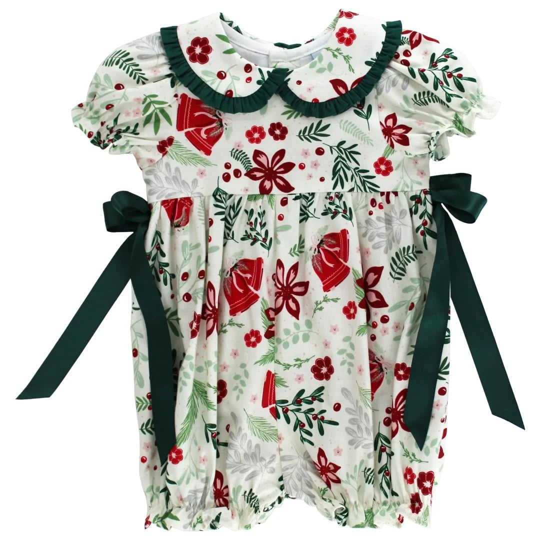 Christmas-themed baby romper with red flowers, green leaves, and black ribbons on a white background