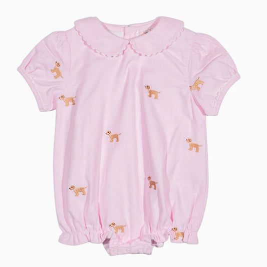 A light pink short-sleeve baby romper with a Peter Pan collar, gathered elastic cuffs, and embroidered dog motifs scattered across the front, shown against a plain white background.