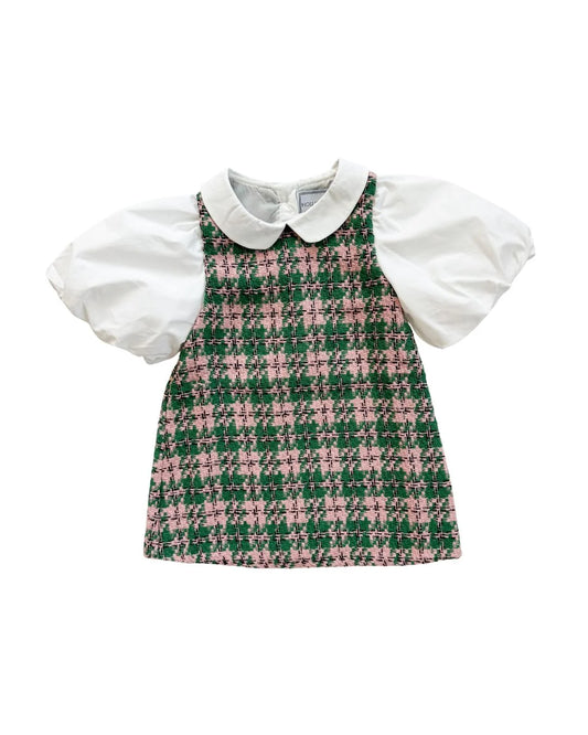 A toddler girl's dress featuring a green and pink houndstooth patterned body with a white Peter Pan collar and white puff sleeves, shown flat on a white background.