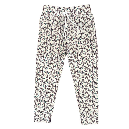 A pair of jogger-style pants with an all-over duck print on a white background, featuring a white drawstring waist and elastic cuffs.