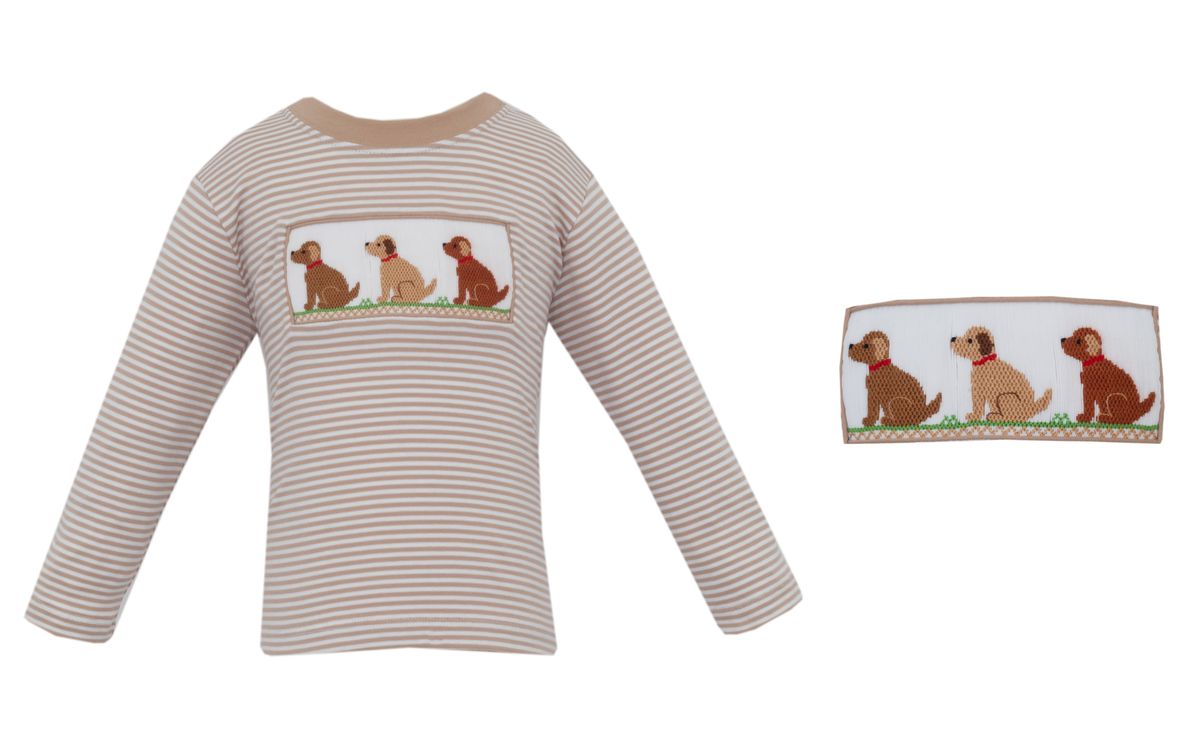 A long-sleeve brown striped shirt with beige and white horizontal stripes, featuring a rectangular patch on the chest with illustrations of three dogs. A close-up inset on the right shows the details of the dog patch.
