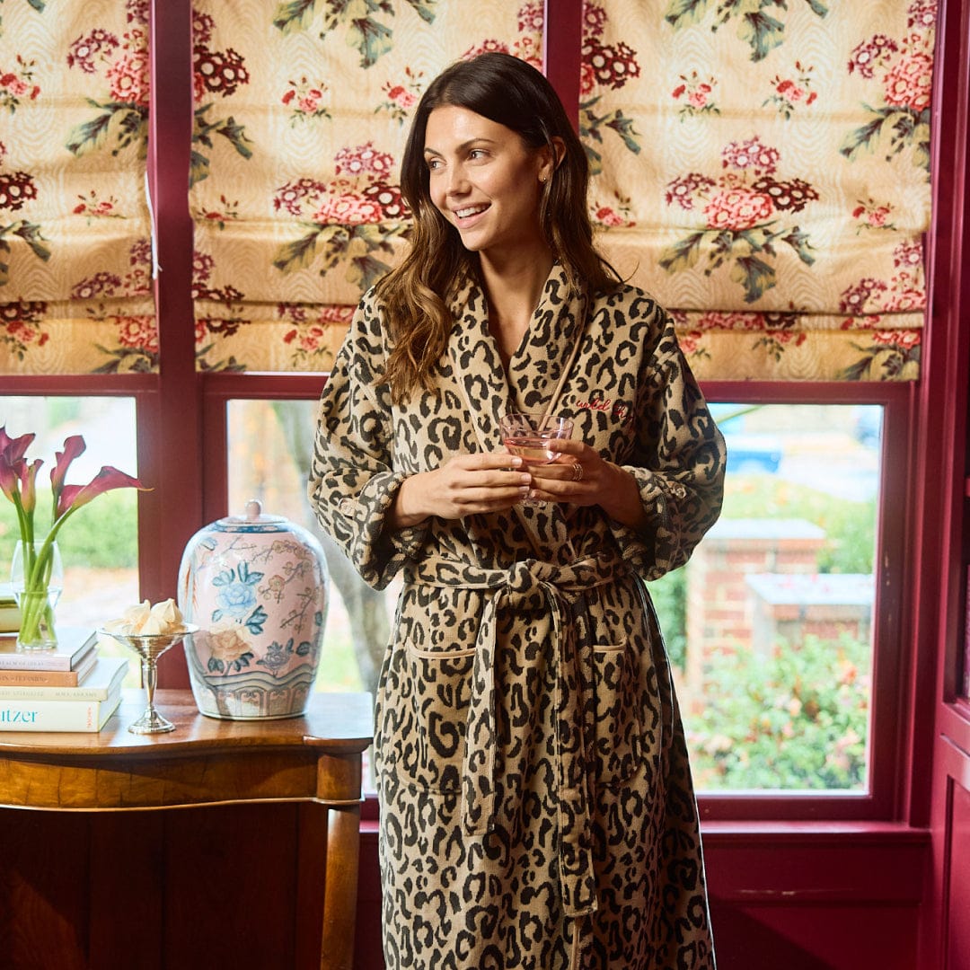 Plush robe with brown and black leopard print all over it 