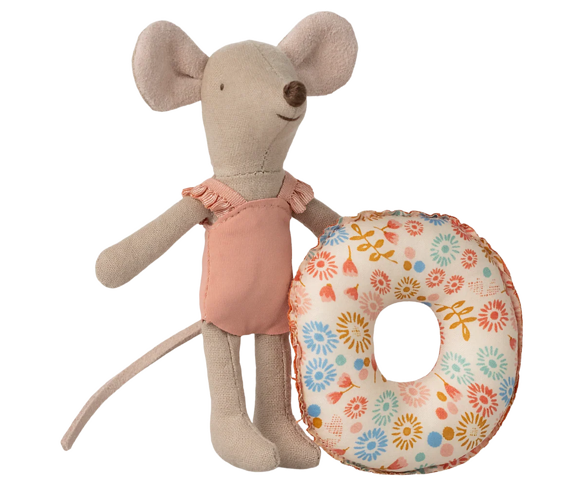 Stuffed mouse toy holding a floral cushion on a white background