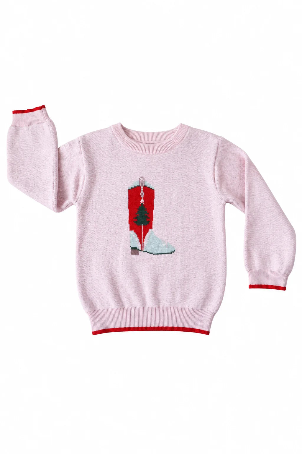A light pink knit crewneck sweater with red trim on the cuffs, hem, and collar, featuring a central graphic of a red cowboy boot with a green Christmas tree and white snow.