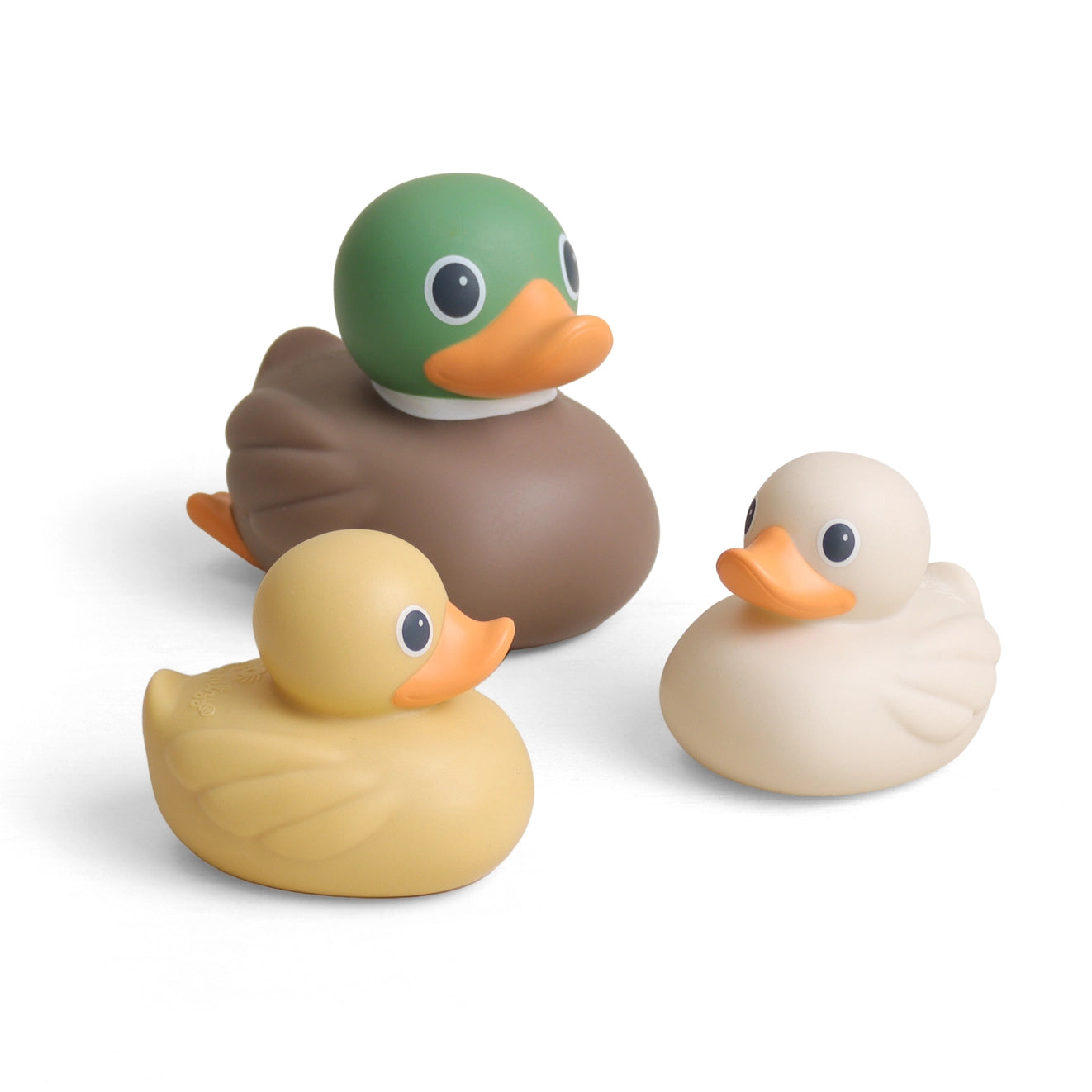 Three rubber duck toys in different colors: a green-headed duck with a brown body, a yellow duck, and a cream-colored duck