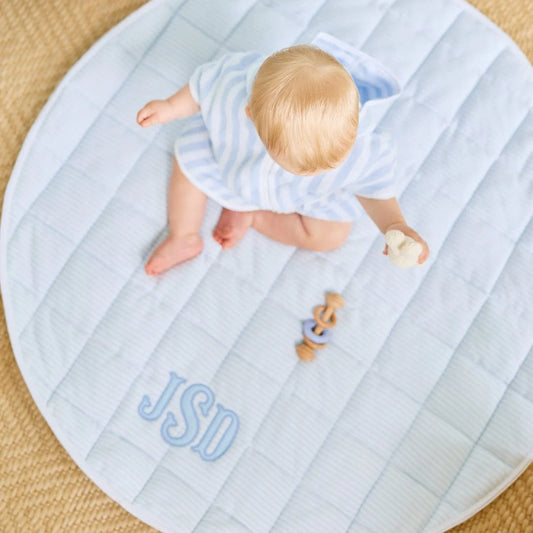Round tummy time mat with blue checkered print 