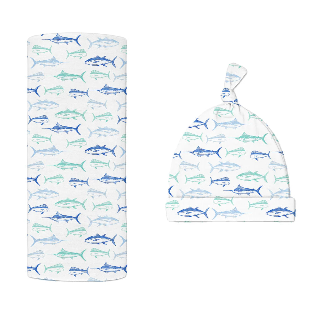 Baby bamboo hat and swaddle blanket set with blue fish pattern on a white background