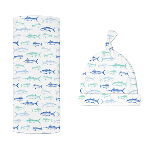 Baby bamboo hat and swaddle blanket set with blue fish pattern on a white background