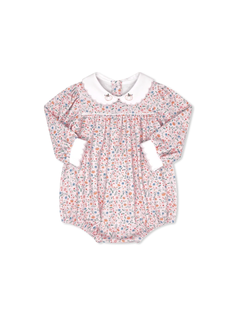 A baby long-sleeve romper with a delicate multicolor floral print on a white base, featuring a contrasting white Peter Pan collar and white ruffled cuffs.
