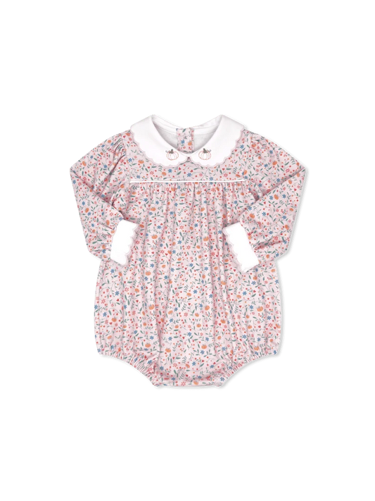 A baby long-sleeve romper with a delicate multicolor floral print on a white base, featuring a contrasting white Peter Pan collar and white ruffled cuffs.