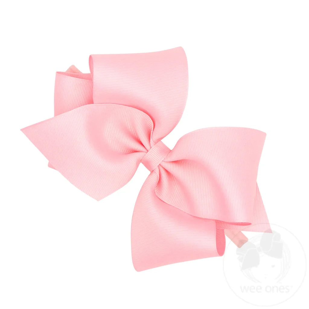 A mini king light pink hair bow band made of grosgrain ribbon 