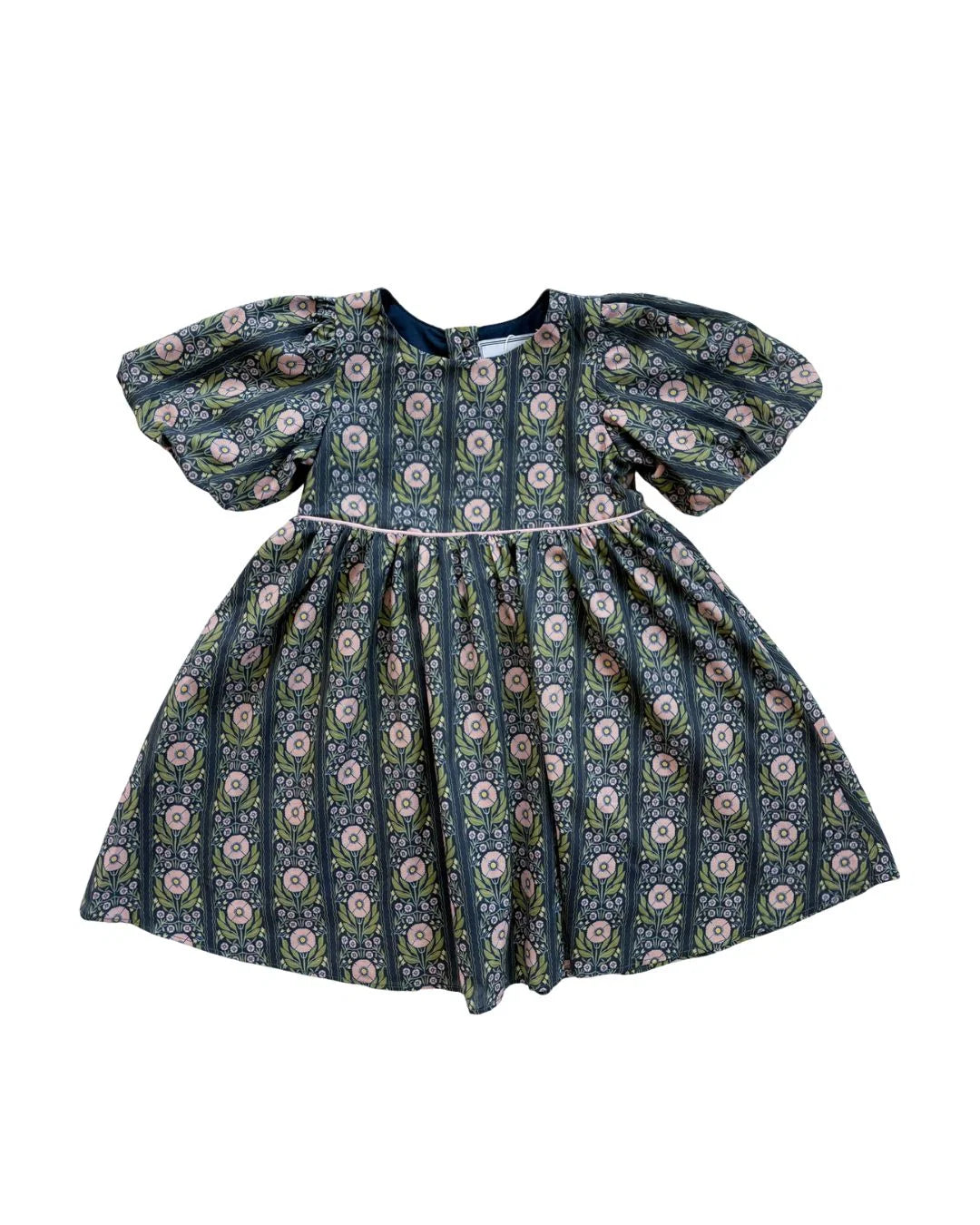 A toddler girl's dress with puff sleeves and a gathered skirt, featuring an all-over vertical floral pattern in navy blue, sage green, and pink on a white background.