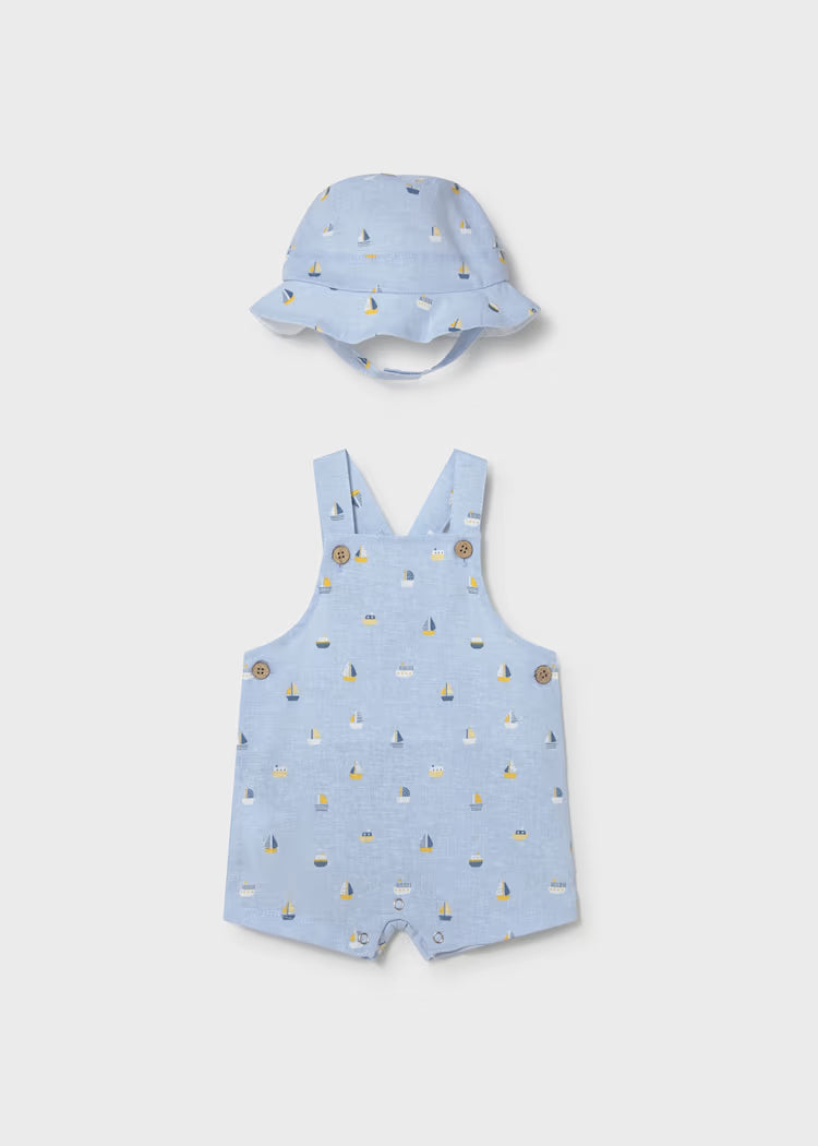 Light blue romper and hat set with sailboat design.