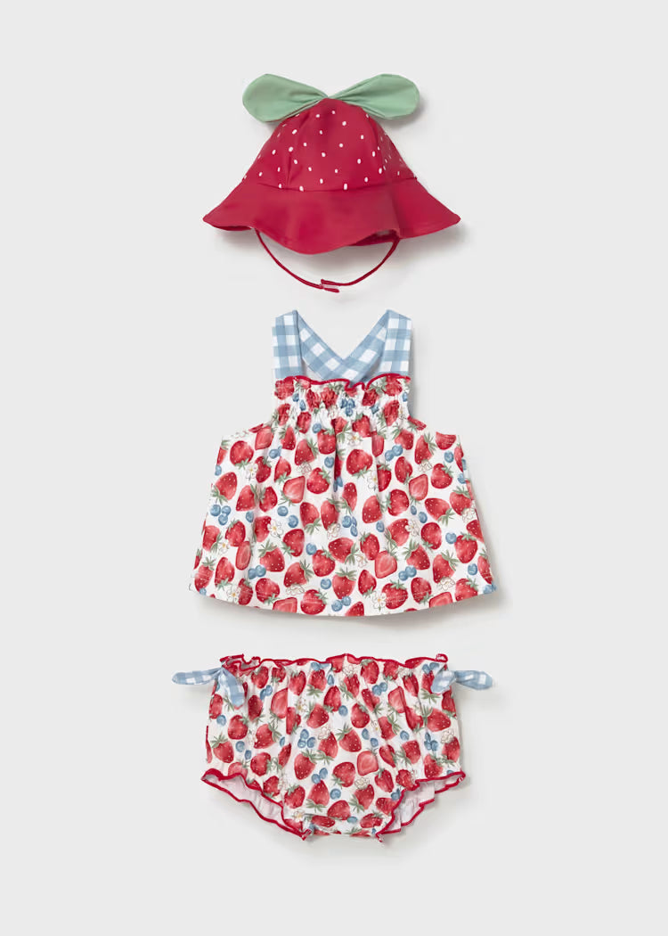 Strawberry patterned two piece swimsuit with blue gingham trim and coordinating hat.
