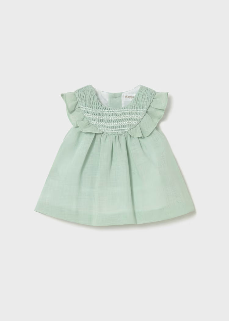 Pale green smocked dress with ruffles