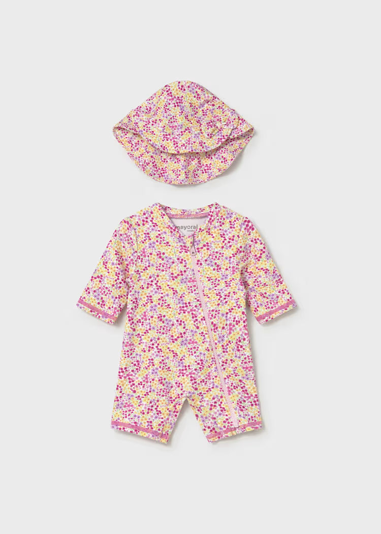 Pink and yellow floral one piece sun protection swimsuit with matching hat.