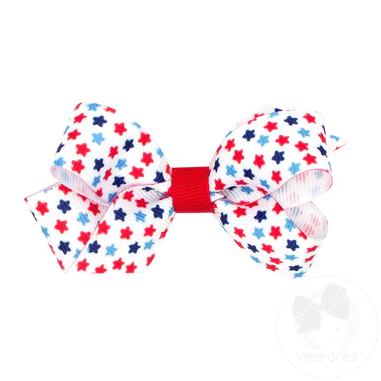 White hair bow with red and blue stars.
