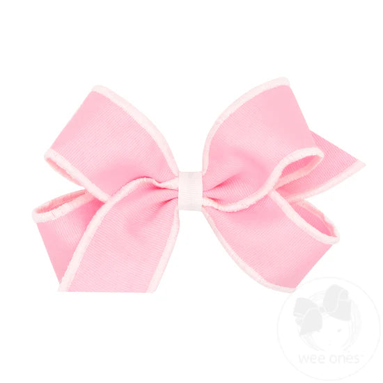 Pink bow with white serged edge.