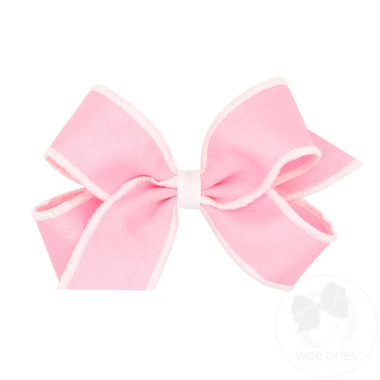 Pink bow with white serged edge.