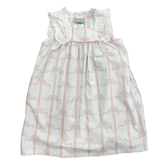 Pink bow pattern on white dress with eyelet lace trim.