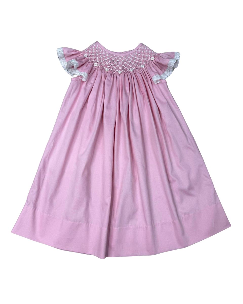 Pink smocked dress with lace sleeves and pearl detail on smocking.