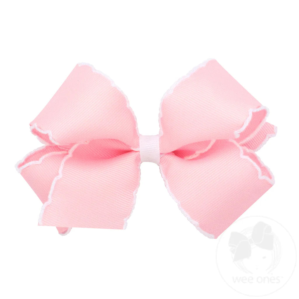 Medium light pink bow with white moonstitch trim