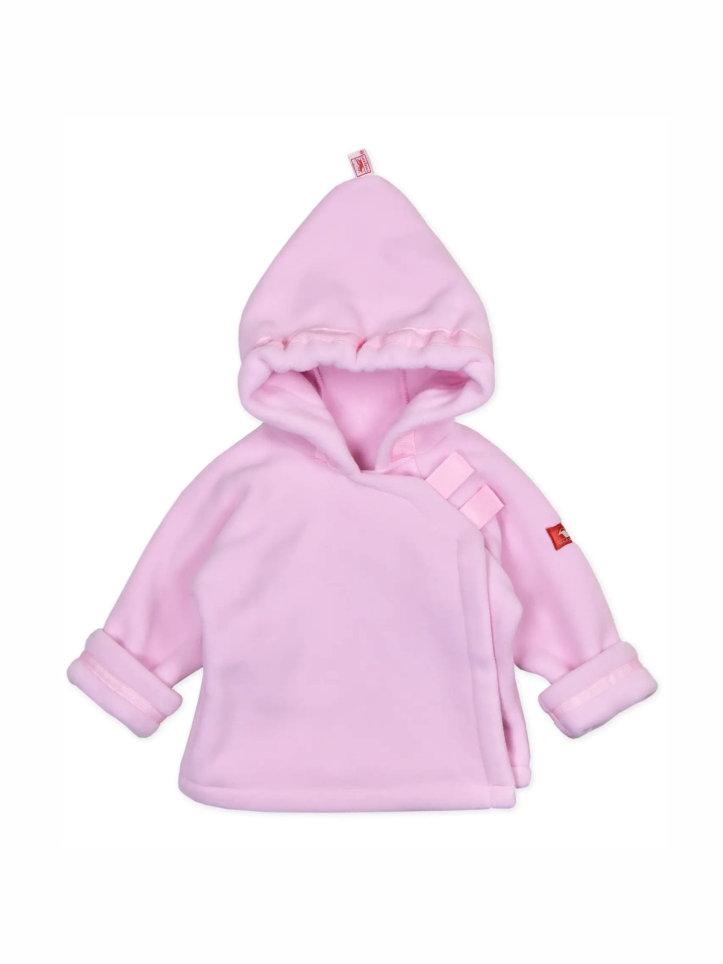 A light pink baby hooded wrap jacket with a plush fleece texture, featuring a small red brand tag on the sleeve and a matching pink drawstring detail on the chest.