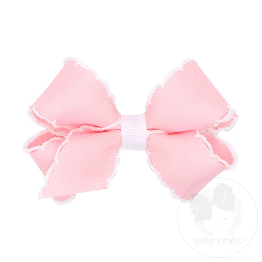 Pink hair bow with white moonstitch edging.
