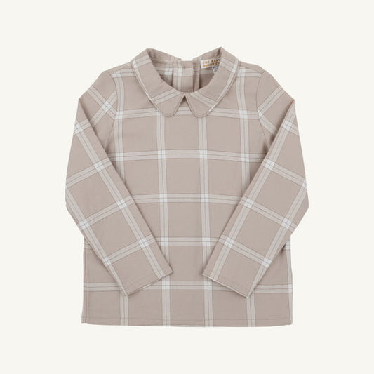 A long-sleeve collared shirt in a warm beige/tan color with a white windowpane plaid pattern, laid flat against a light cream background.
