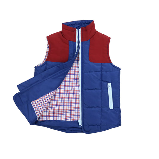 A children's quilted puffer vest with a split color design of red and royal blue, featuring a white zipper and a red, white, and blue checkered lining.