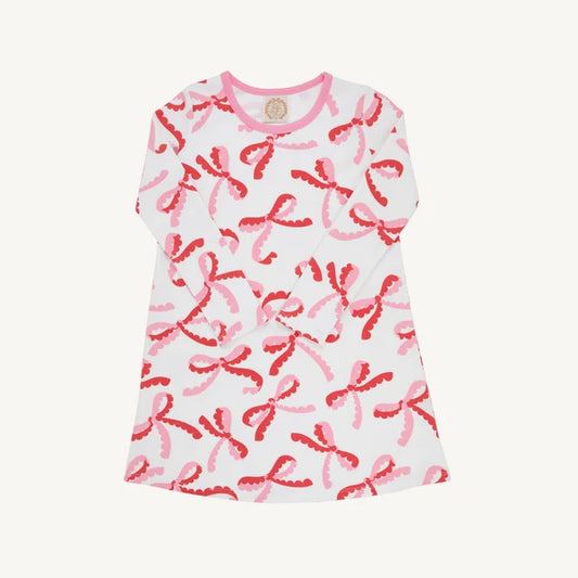 Long sleeve white play dress with red and pink bow pattern all over 