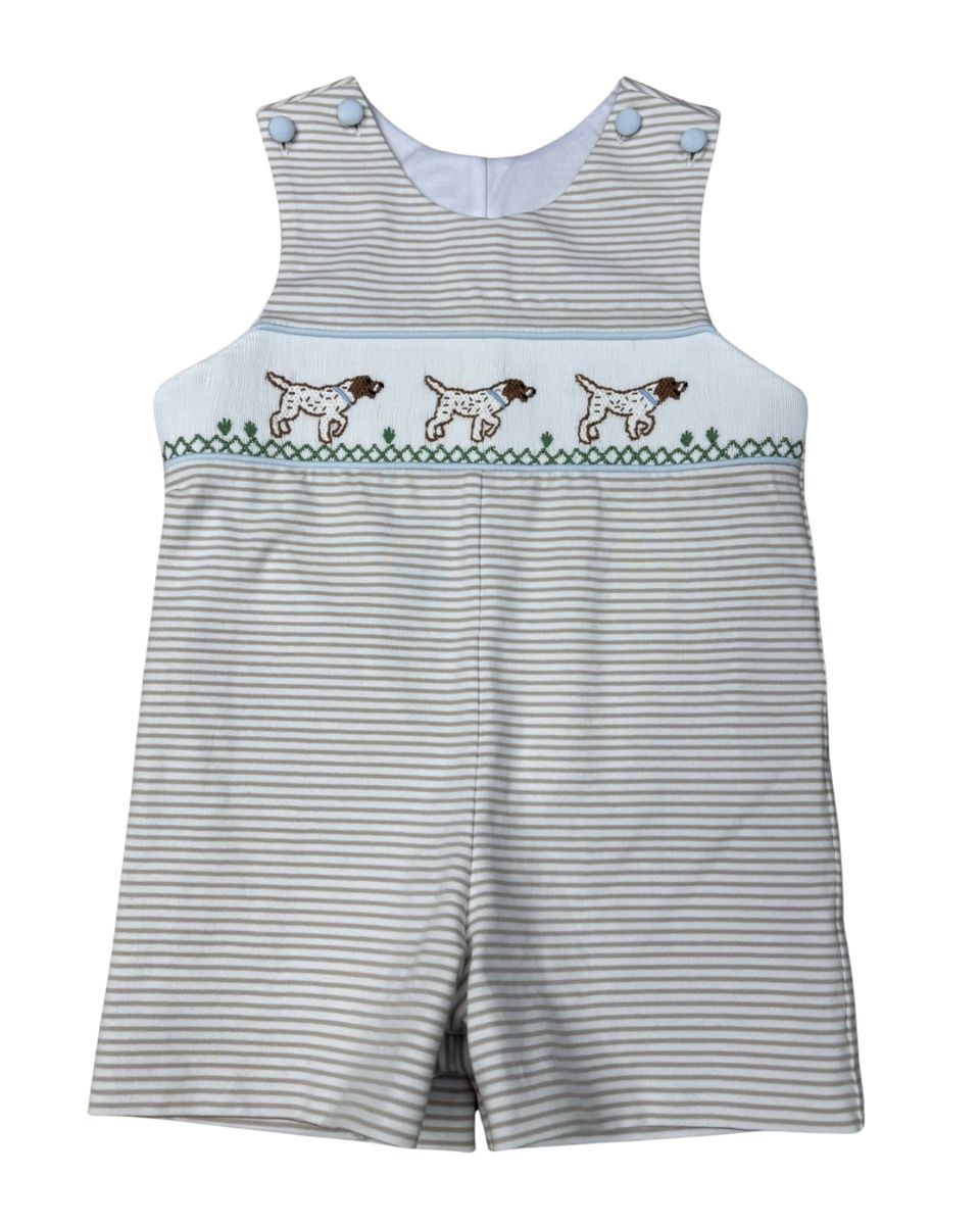 Tan and white Striped baby romper with a smocked dog design on a white background