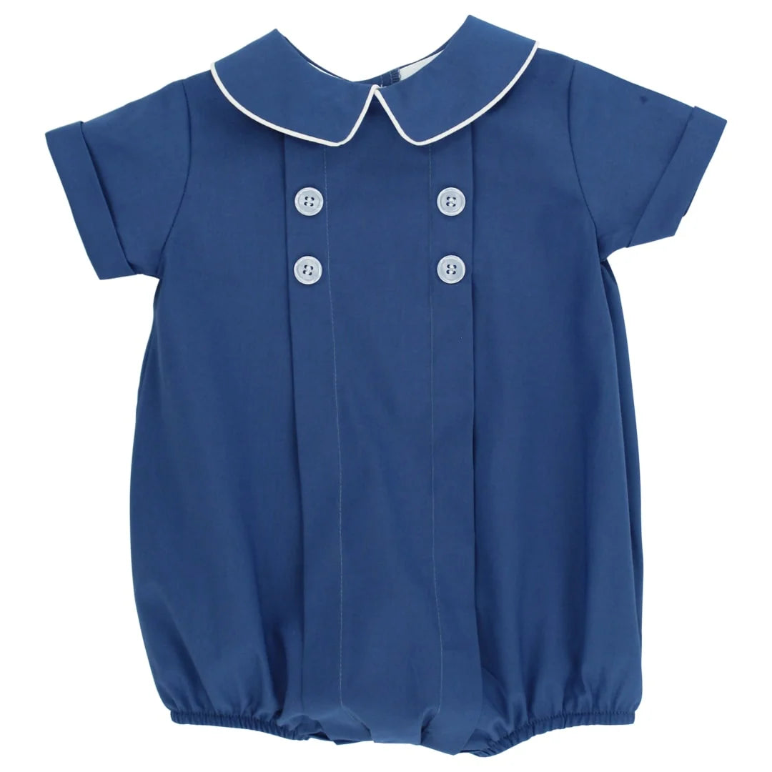 A short-sleeve baby bubble romper in cornflower blue with a white piped Peter Pan collar and white decorative buttons on the front, shown against a plain white background.
