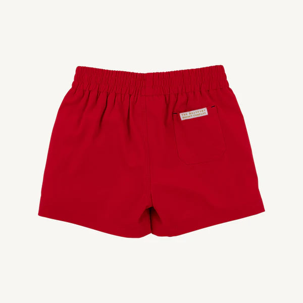 Red athletic shorts with a small label on the back pocket with brand name 