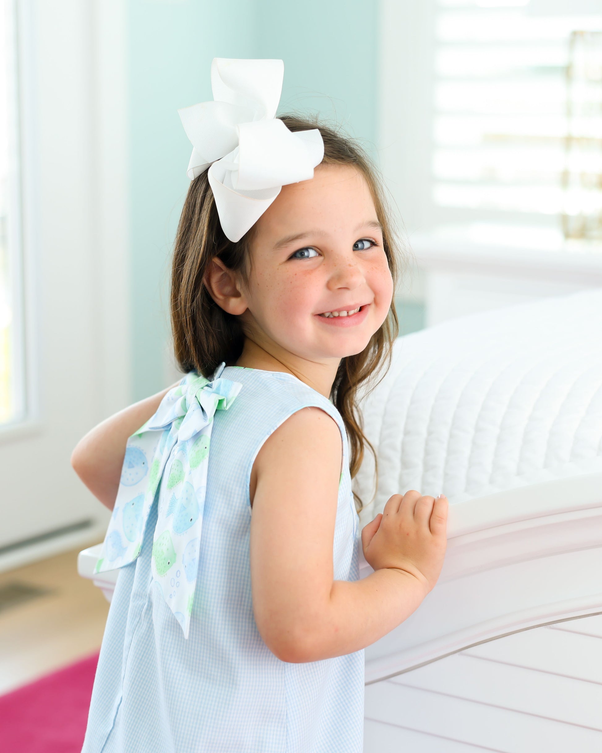 Light blue dress with puffer fish design with bows in the back 