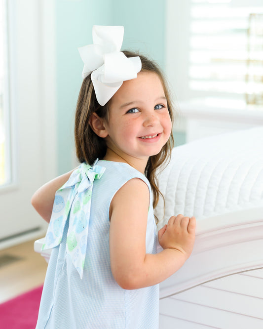 Light blue dress with puffer fish design with bows in the back 
