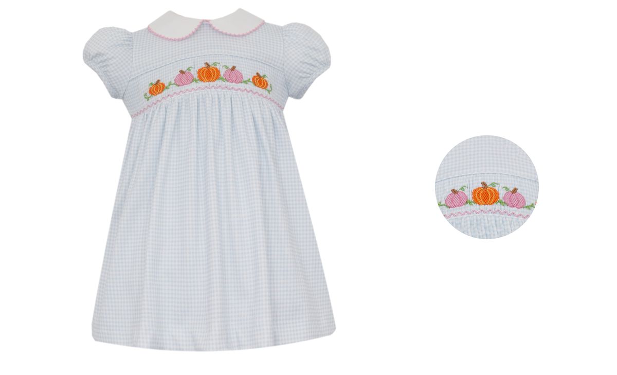 White checkered dress with embroidered pumpkins on a white background